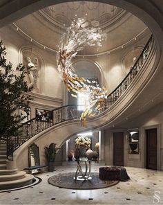 an elegant staircase with chandelier and flowers in vases on the center table