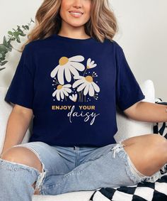 Introducing our "Enjoy Your Daisy" shirt.   This retro floral T-shirt, is a vibrant celebration of nature's beauty.  This tee is a minimalist shirt for women and makes the perfect best friend gift! ------------------------------------------------------------------------- HOW TO ORDER ------------------------------------------------------------------------- >  Check and Review all Photos and Size Chart >  Select the size and color option from the drop-down menu >  Select "Add to Cart"   Select pr Blue Floral Print Graphic Tee, Blue Graphic Tee With Floral Print, Blue Floral Print Graphic Tee Shirt, Summer Daisy Print Crew Neck Shirt, Summer Crew Neck Shirt With Daisy Print, Crew Neck Daisy Print Shirt For Summer, Crew Neck Shirt With Daisy Print For Summer, Daisy Shirt, Mom Best Friend