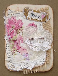 a piece of paper with lace and flowers on it