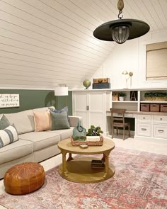 a living room filled with furniture and a large rug on top of a wooden floor