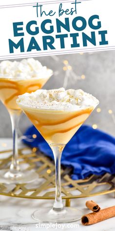 two glasses filled with eggnog martini on top of a table