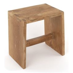 a small wooden stool sitting on top of a white floor