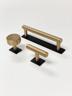 three brass handles and two black bases