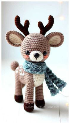 a crocheted stuffed animal with antlers on it's head and scarf around its neck