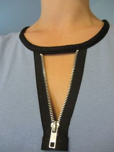 a woman wearing a necklace with an open zipper on the front and back of her neck