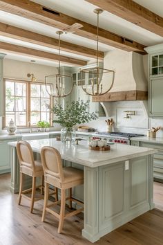 a kitchen with an island and two chairs in the center, surrounded by wooden beams