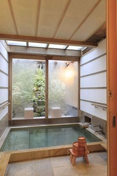 the inside of a room with a large window and an indoor hot tub in it