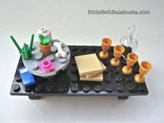 a lego table with cups and vases on it