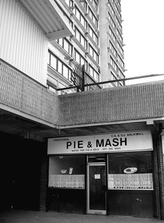 a black and white photo of a pie and mash store