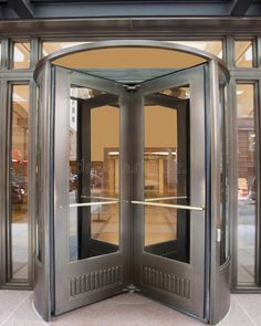 an open double door on the outside of a building with glass and metal trimmings