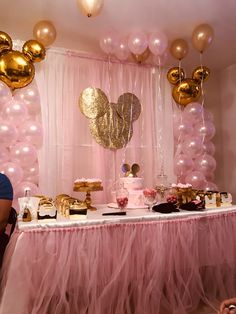 a table topped with lots of desserts and balloons in front of a pink backdrop