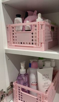 two shelves filled with different types of bathroom products and personal care items in pink baskets