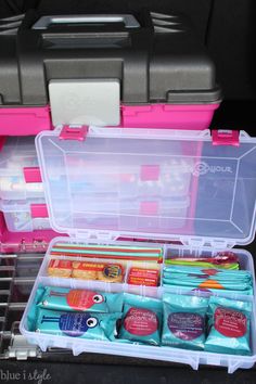 the inside of a pink and gray case filled with supplies