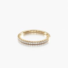 a yellow gold ring with three rows of diamonds on the inside and outside of it