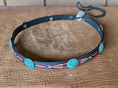 This hitched webbing hatband has a black leather base that is 15mm wide. Copper patina southwest style Conchos accent the band. Ties on with the deertan lace, slide the deer antler bead bead up to "tighten and tie 2 knots in the lace to secure the band. 23" long. Looks great on both palm and felt hats. Hat not included. Bohemian Adjustable Concho Hat Bands, Bohemian Concho Hat Bands Adjustable, Adjustable Bohemian Concho Hat Bands, Traditional Adjustable Jewelry For Rodeo, Southwestern Adjustable Hat Band With Concho, Adjustable Southwestern Hat Band With Concho, Southwestern Adjustable Black Hat Bands, Antler Beads, Desert Moon