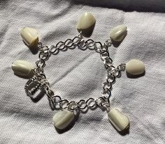 "Creepily pretty mother pf pearl \"tooth\" bracelet made from gemstone nuggets of mother of pearl that look uncannily like real teeth!  Perfect accessory for Hallowe'en.  Would suit Dentist with sense of humour." Teeth Bracelet, Tooth Bracelet, Sense Of Humour, Pretty Necklaces, Summer Fabrics, Pinterest Board, Charm Bracelets, Bracelet Making, Mother Of Pearl