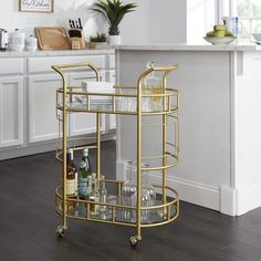 a gold bar cart filled with bottles and glasses