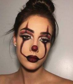 a woman with makeup painted to look like a clown's nose and nose ring