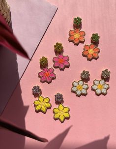 Beautiful, playful earrings with brightly coloured daisies. The perfect feel-good earring!Hand beaded, each pair of earrings takes approximately four hours to create, and is bright, bold and fun!I’ve paired the daisies with bright colourful glass crystals to make them even more of a statement pop of colour.Choose from:hot pink with yellow crystalssunkissed orange with lime crystalstraditional white with clear crystalsor bright yellow with lilac crystals.I designed the FLOWERS collection to add a Multicolor Summer Flower Charm Earrings, Summer Multicolor Flower Charm Earrings, Handmade Colorful Flower Earrings, Summer Multicolor Earrings With Flower Charm, Multicolor Beaded Flower Earrings With Flower Charm, Multicolor Flower Shaped Beaded Earrings With Flower Charm, Multicolor Flower-shaped Beaded Earrings With Flower Charm, Playful Handmade Multicolor Flower Earrings, Playful Multicolor Handmade Flower Earrings