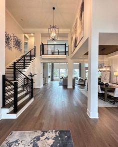 a large open floor plan with stairs leading up to the second story and dining room