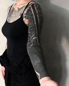 a woman with tattoos on her arm and arms