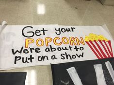 a sign that says get your popcorn we're about to put on a show