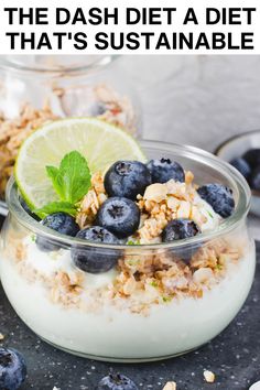 a bowl filled with yogurt, granola and blueberries on top of a table