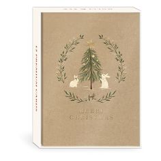 a christmas card with an image of a tree and two rabbits in the center, surrounded by greenery