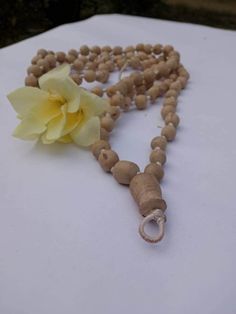 "Introducing our exquisite Tulsi Japa Mala, a sacred accessory designed for meditation and prayer, crafted with utmost care and devotion. This spiritual tool is handcrafted with precision, featuring 108 Spherical beads made from the sacred Tulsi wood. Each bead is a testament to the rich tradition and cultural significance that Tulsi holds in spiritual practices. Mala Length 40 inches. The Tulsi Japa Mala boasts a unique design, with its Spherical beads gradually decreasing in size from a substantial bead size of 2 cm to a smaller, delicate size of 1.5 cm. This meticulously crafted arrangement not only enhances the aesthetic appeal of the Mala but also ensures a comfortable grip and smooth touch, allowing your fingers to glide over the beads effortlessly during your meditation and prayer s Natural Hand-strung Beaded Necklace As A Gift, Natural Beaded Necklace As Gift, Spiritual Wooden Beaded Necklaces For Festivals, Spiritual Style Natural Beaded Necklace Gift, Healing Festivals Necklace With Wooden Beads, Spiritual Necklace With 108 Natural Beads, Spiritual Natural Beaded Necklaces As Gift, Spiritual Natural Jewelry For Meditation, Spiritual Natural Beaded Necklace Gift