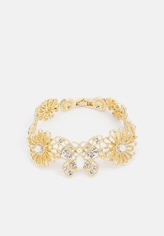 Discover the "Marquise" golden floral bracelet, a piece of jewelry that embodies elegance and glamour. This refined bracelet is crafted from zinc, acrylic and glass, and adorned with a shiny polished finish. Decorative crystals and imitation pearls add a touch of luxury, perfect for enhancing anyone. With a circumference of 7.5 inches and a width of 1 inch, this bracelet provides a comfortable fit while making a bold style statement. The delicate floral pattern is ideal for those who provide nat Luxury Elegant Bracelets With Polished Beads, Luxury Statement Bracelets With Shiny Finish, Luxury Glamorous Crystal Bracelets, Luxury Statement Bracelet With Shiny Finish, Luxury Shiny Finish Bracelet, Luxury Shiny Finish Bracelets, Decorative Crystals, Shiny Rings, Lucky Jewelry