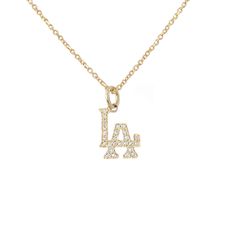 This detailed classic Los Angeles logo charm pendant is composed of 14K solid gold and finished with GVS1 quality natural real diamonds covering the entire surface. This charm is beautifully complemented by a durable yet delicate 14K solid gold adjustable chain, finished with a secure lobster claw clasp and Nana Bijou signature logo tag. This charm is also available to be purchased as a charm alone without the chain. LA Pendant Dimensions (not including the bail): approximately 6mm (w) x 7mm (h) Luxury White Gold Necklace With Logo Charm, Luxury Gold Charm Necklace With Logo, Channel Necklace Logo Gold Pendant, Luxury White Necklaces With Logo Charm, Luxury Sterling Silver Necklace With Logo Charm, Luxury Gold Chain Necklace With Logo Charm, Luxury White Necklace With Logo Charm, Luxury Logo Charm Necklaces, Luxury Logo Charm Necklace