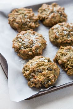 some cookies are sitting on a piece of parchment paper and ready to be eaten by someone