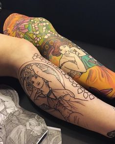 two people with tattoos on their legs sitting next to each other