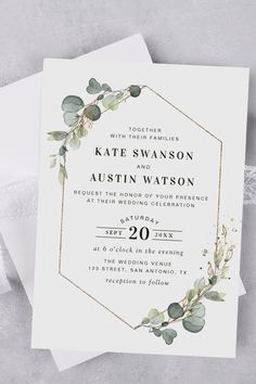 an elegant wedding card with greenery on the front and bottom, in gold foil