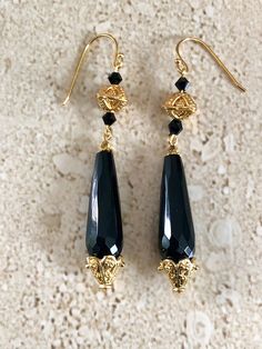 Onyx Earrings. Stunning black onyx earrings featuring a faceted teardrop black onyx stone accented with Gold over copper Bali style bead caps and 4MM black Swarovski crystals.  Earwires are gold filled and measure 2 1/2 inches long. GIFT BOXED Elegant Teardrop Black Bead Jewelry, Elegant Teardrop Black Beaded Jewelry, Elegant Black Long Drop Jewelry, Black Pierced Crystal Earrings For Party, Evening Black Bead Drop Earrings, Gothic Drop Earrings For Formal Occasions, Gothic Black Drop Earrings, Elegant Onyx Earrings For Party, Elegant Single Black Earring