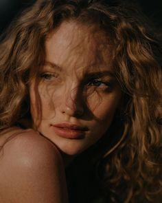 a close up of a woman with curly hair