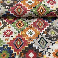 a multicolored rug with many different designs on it