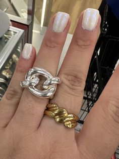 a woman's hand with two rings on it and one ring in the middle