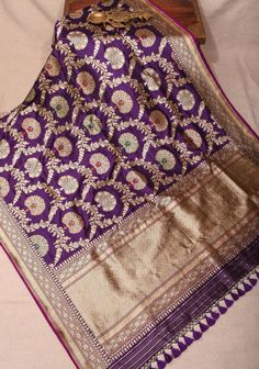 Introducing our Authentic Kadhuwa Jungla Banarasi Floral Meenkari Jaal Katan Silk Saree in Deep Purple, a magnificent embodiment of traditional Indian craftsmanship. This exquisite saree features a beautifully intricate floral meenkari jaal design that showcases the rich artistry of Banarasi weavers. The deep purple fabric serves as a regal backdrop, accentuating the vibrant motifs and adding depth to the overall aesthetic. Crafted from luxurious Katan silk, this saree drapes effortlessly, providing both comfort and elegance. Perfect for weddings, festive occasions, or special gatherings, this saree is a timeless piece that celebrates the heritage of Indian textiles while making a striking statement. SILK MARK CERTIFIED This saree is ready to wear with fall and Pico done. Handmade silk tas Jaal Design, Saree Drapes, Katan Silk Saree, Indian Textiles, Katan Silk, Purple Fabric, Purple Silk, Traditional Indian, Salwar Kameez