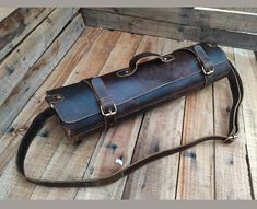 a brown leather bag sitting on top of a wooden floor