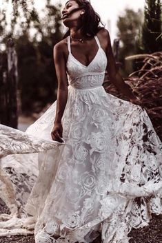 a woman in a white dress is standing on the ground and looking up at something