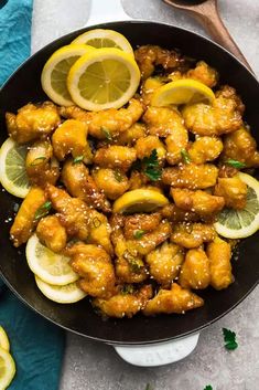 chicken wings with lemons and parsley in a skillet