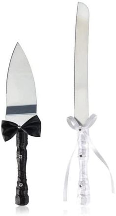 a knife with a bow tied around it's neck and another knife in the background