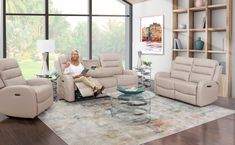 a woman sitting in a living room with two recliners