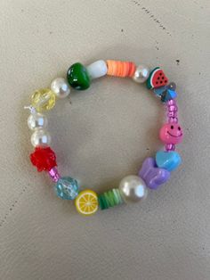 Rose, mushroom, polymer, faux pearl, lemon, watermelon and seed beads. Fits small to medium wrists. Fun Beaded Stretch Bracelet For Summer, Playful Multicolor Beaded Bracelets For Summer, Playful Colorful Beads Stretch Bracelet For Summer, Playful Stretch Bracelet With Colorful Beads For Summer, Summer Bracelets With Heart And Round Beads, Playful Beaded Stretch Bracelet For Summer, Fun Yellow Beaded Bracelets For Summer, Fun Yellow Beaded Bracelet For Summer, Fun Green Beaded Stretch Bracelet