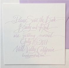 a white card with purple ink on it