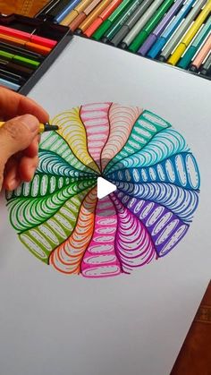 someone is drawing something with colored pencils