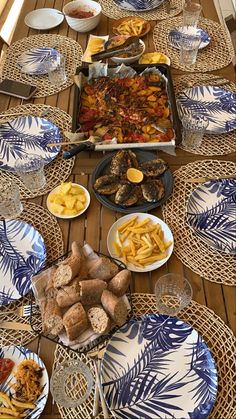 a table topped with plates and bowls filled with different types of food next to each other