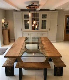 a wooden table sitting in the middle of a kitchen