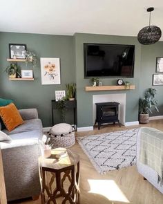 a living room filled with furniture and a flat screen tv mounted on the wall above a fire place